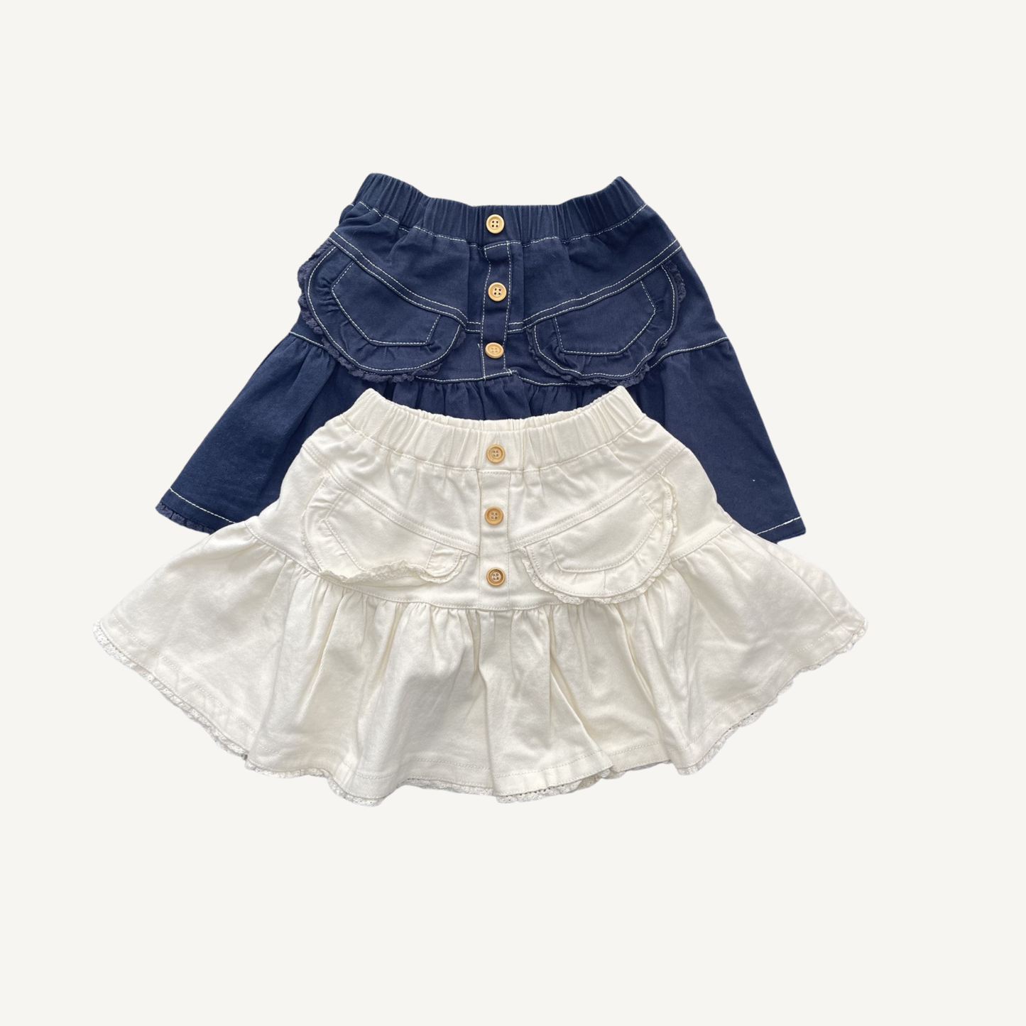 Kids denim skirt in cream and navy with soft flare silhouette and elastic waistband — CHÉRUBI Kidswear.